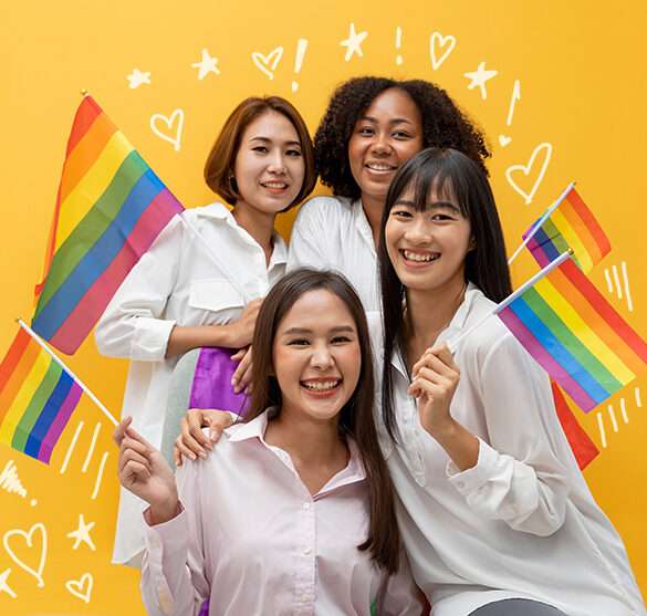 a photo of a group of smiling people holding pride flags